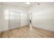 A bedroom with hardwood floors, ceiling fan, closet and open door at 2337 Worthington Rd, Maitland, FL 32751