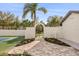 Gated entrance to the backyard tennis court featuring manicured landscaping at 2337 Worthington Rd, Maitland, FL 32751
