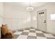 Bright entryway features a decorative chandelier, board and batten trim, and a checkered floor at 2337 Worthington Rd, Maitland, FL 32751