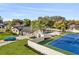 Aerial view showcases a backyard pool, tennis court, manicured lawn, and a modern home at 2337 Worthington Rd, Maitland, FL 32751