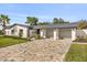 Charming home features a patterned driveway, a three car garage, and manicured landscaping at 2337 Worthington Rd, Maitland, FL 32751