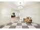 Elegant foyer featuring a decorative chandelier, board and batten wall accents, and checkered tile flooring at 2337 Worthington Rd, Maitland, FL 32751