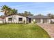 A beautiful home with a green lawn, brick driveway and a spacious three car garage at 2337 Worthington Rd, Maitland, FL 32751