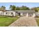 This home features a well-manicured lawn, updated paint, brick driveway, and a three-car garage at 2337 Worthington Rd, Maitland, FL 32751