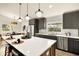 Stylish kitchen features a large island, stainless steel appliances, and gray cabinetry at 2337 Worthington Rd, Maitland, FL 32751