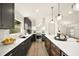 Modern kitchen features stainless steel appliances, an island, and light fixtures that add ambiance to the space at 2337 Worthington Rd, Maitland, FL 32751
