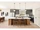 Kitchen features a central island with barstool seating, modern lighting, and stainless steel appliances at 2337 Worthington Rd, Maitland, FL 32751