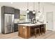 This modern kitchen features stainless steel appliances, a large island, and gray cabinetry at 2337 Worthington Rd, Maitland, FL 32751