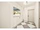 Bright laundry room with checkerboard tile floor, window, and utility connections at 2337 Worthington Rd, Maitland, FL 32751
