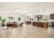 Bright open floorplan features a skylight, modern furnishings, and a kitchen island with pendant lighting at 2337 Worthington Rd, Maitland, FL 32751