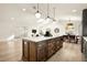 Bright open floorplan features a large kitchen island, dining area, and stylish living room at 2337 Worthington Rd, Maitland, FL 32751