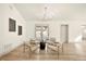 Bright living room features modern chandelier, light floors and double doors to backyard at 2337 Worthington Rd, Maitland, FL 32751
