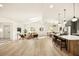 Bright open floorplan features a skylight, modern furnishings, and a kitchen island with pendant lighting at 2337 Worthington Rd, Maitland, FL 32751