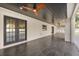A covered patio features dark tile, a ceiling fan, and access to the backyard at 2337 Worthington Rd, Maitland, FL 32751
