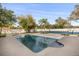 Relaxing backyard pool area with a tennis court, surrounded by lush greenery and a privacy fence at 2337 Worthington Rd, Maitland, FL 32751