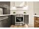 Modern stainless steel stove sits between custom cabinets with updated white marble backsplash at 2337 Worthington Rd, Maitland, FL 32751