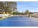 Well-maintained tennis court surrounded by mature trees and landscaping, with home in the background at 2337 Worthington Rd, Maitland, FL 32751
