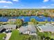 Aerial view of a beautiful home with a large backyard, mature trees, and private lake access at 2631 Falmouth Rd, Maitland, FL 32751
