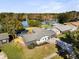 Aerial view of a modern home with a brick driveway and a swimming pool with a lake view at 2631 Falmouth Rd, Maitland, FL 32751