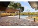 Backyard pool area with a wooden pergola and a brick patio overlooking a pond at 2631 Falmouth Rd, Maitland, FL 32751