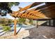 Backyard pool area with a wooden pergola and a brick patio overlooking a pond at 2631 Falmouth Rd, Maitland, FL 32751