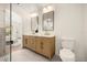 Modern bathroom featuring a double sink vanity, stylish mirrors, and a glass-enclosed shower at 2631 Falmouth Rd, Maitland, FL 32751