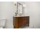 Bathroom featuring wood vanity with marble countertop, gold hardware, and decorative mirror at 2631 Falmouth Rd, Maitland, FL 32751