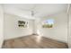 Bright bedroom with hardwood floors, a ceiling fan, and two windows overlooking the yard at 2631 Falmouth Rd, Maitland, FL 32751