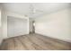 Bright bedroom with light gray closet doors and wood-look flooring at 2631 Falmouth Rd, Maitland, FL 32751