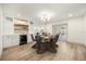 Open dining room with built in wine fridge, modern light fixture, and wood floors at 2631 Falmouth Rd, Maitland, FL 32751