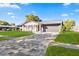 Charming single-story home with a brick paver driveway, lush lawn, and manicured landscaping at 2631 Falmouth Rd, Maitland, FL 32751