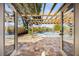 View of the pool, patio, and lake through open glass doors at 2631 Falmouth Rd, Maitland, FL 32751