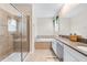 Bathroom with double vanity, soaking tub, and walk-in shower at 2763 Oxymoron Way, Kissimmee, FL 34746