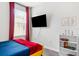 Bedroom with a mounted TV and stylish decor at 2763 Oxymoron Way, Kissimmee, FL 34746