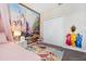 bedroom with a Disney mural, carpet, and built-in closet at 2763 Oxymoron Way, Kissimmee, FL 34746