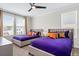 Two twin beds with purple bedding in a well-lit bedroom at 2763 Oxymoron Way, Kissimmee, FL 34746