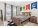 Spacious bedroom with a wooden bed frame and Hogwarts house banners at 2763 Oxymoron Way, Kissimmee, FL 34746