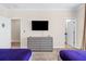 Bedroom with TV, dresser, and access to bathroom at 2763 Oxymoron Way, Kissimmee, FL 34746