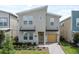 Two story home with a modern exterior and a yellow garage door at 2763 Oxymoron Way, Kissimmee, FL 34746