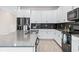 Modern kitchen with white cabinets, dark countertops, and stainless steel appliances at 2763 Oxymoron Way, Kissimmee, FL 34746