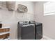 Bright laundry room, featuring washer, dryer, and shelving at 2763 Oxymoron Way, Kissimmee, FL 34746
