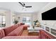 Spacious living room with large sectional sofa and flat-screen TV at 2763 Oxymoron Way, Kissimmee, FL 34746