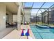Screened pool and spa with patio and cornhole at 2763 Oxymoron Way, Kissimmee, FL 34746