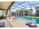 Screened pool and spa with patio and cornhole, backyard view at 2763 Oxymoron Way, Kissimmee, FL 34746