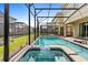 Screened pool and spa with patio and cornhole at 2763 Oxymoron Way, Kissimmee, FL 34746