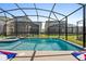 Screened pool and spa with spacious patio and cornhole at 2763 Oxymoron Way, Kissimmee, FL 34746