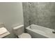 Clean bathroom with a shower/tub combo and tile surround at 3203 Laurent Loop, Davenport, FL 33837