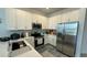 Modern kitchen with stainless steel appliances and white cabinets at 3203 Laurent Loop, Davenport, FL 33837