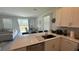 Open kitchen with island, stainless steel appliances, and view into dining area at 3203 Laurent Loop, Davenport, FL 33837