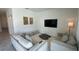 Bright living room featuring comfortable seating and a large TV at 3203 Laurent Loop, Davenport, FL 33837